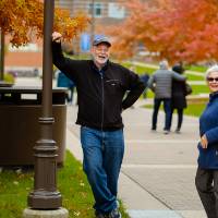 Man and woman enjoy taking their own pictures on campus